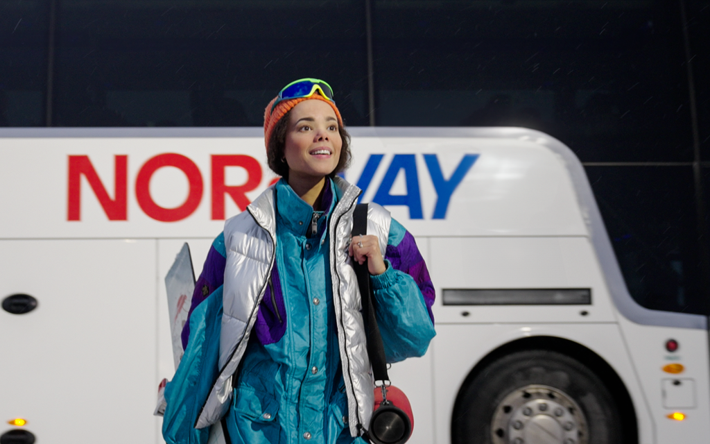 Winter dressed person outside a NOR-WAY bus