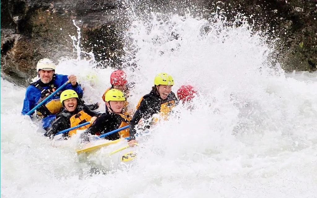 people rafting in a wild river