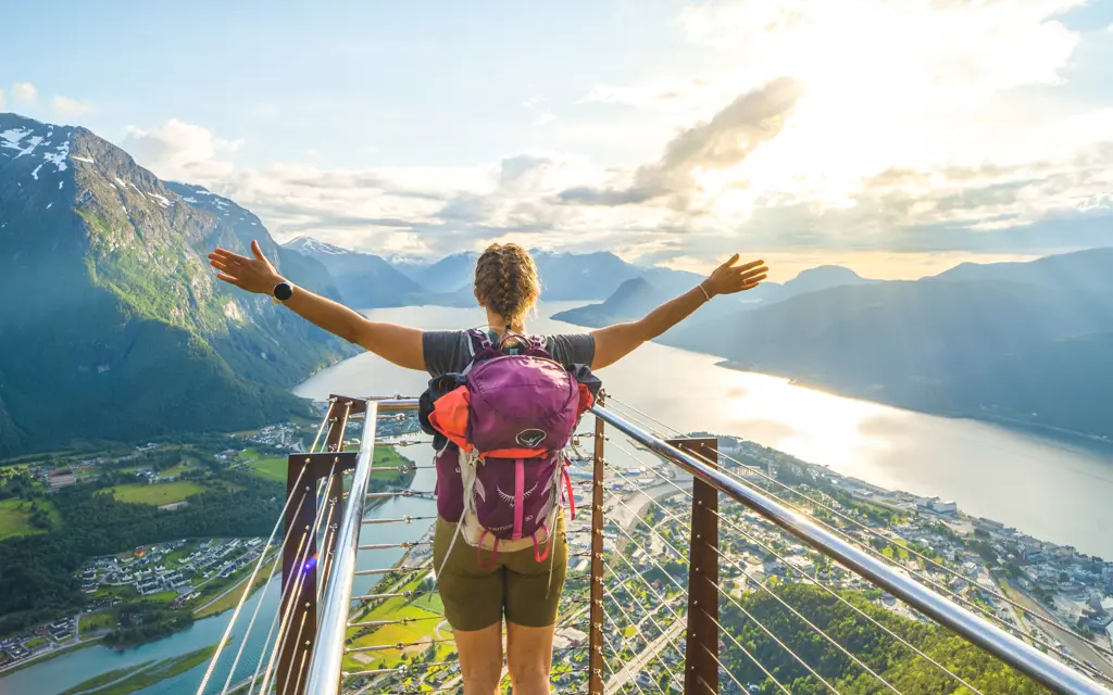 Hiker overlooking the view of Romsdalen from the lookout viewpoint Rampestreken.