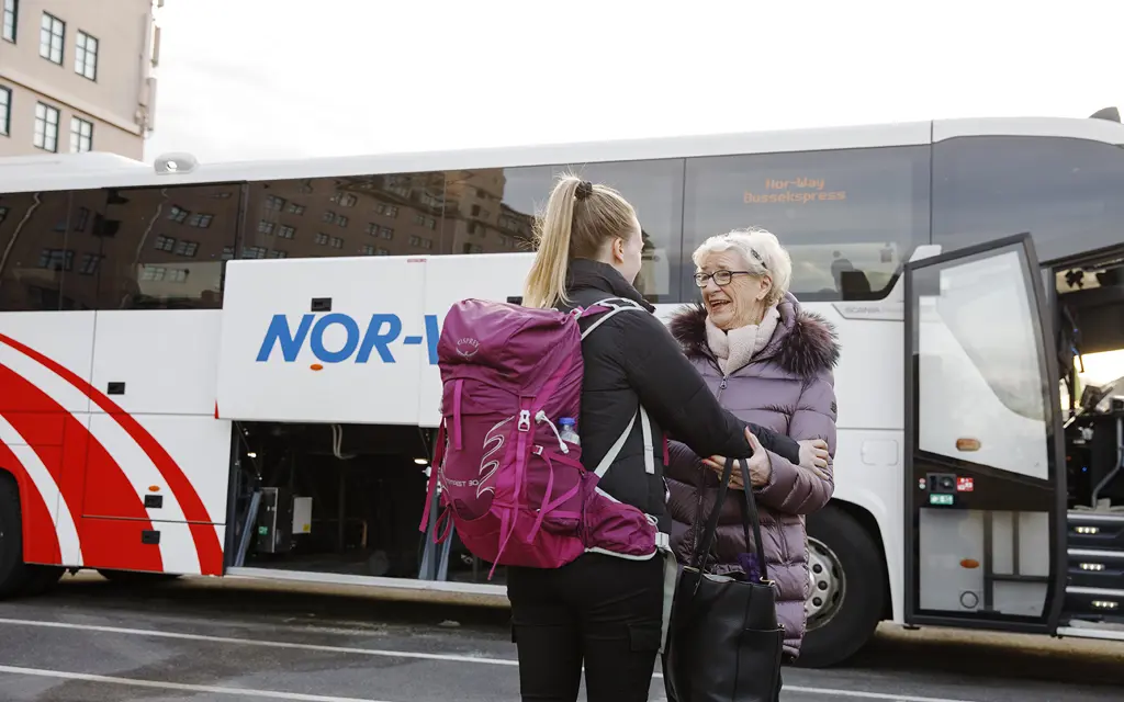 Young and elder lady meets outside the bus