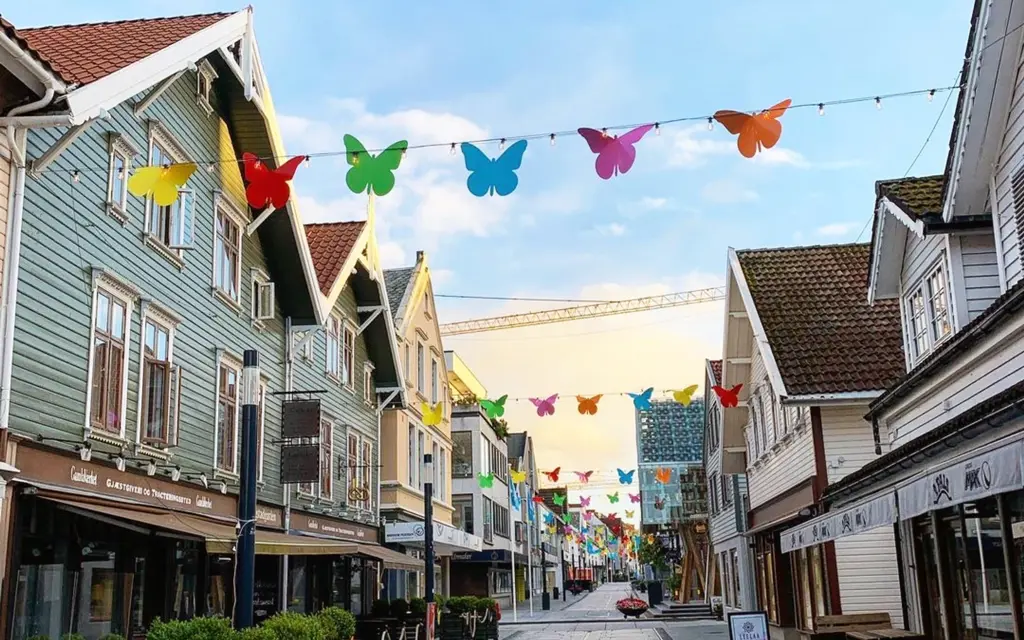 Shopping street in Sandnes with wooden houses and butterfly pennants