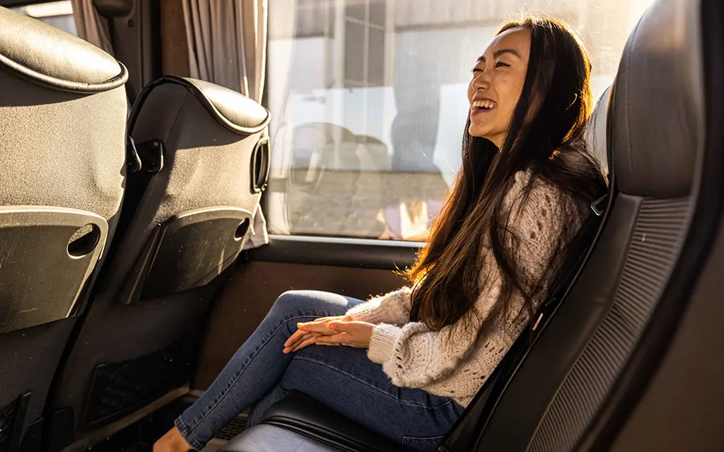 Smiling girl in a bus seat