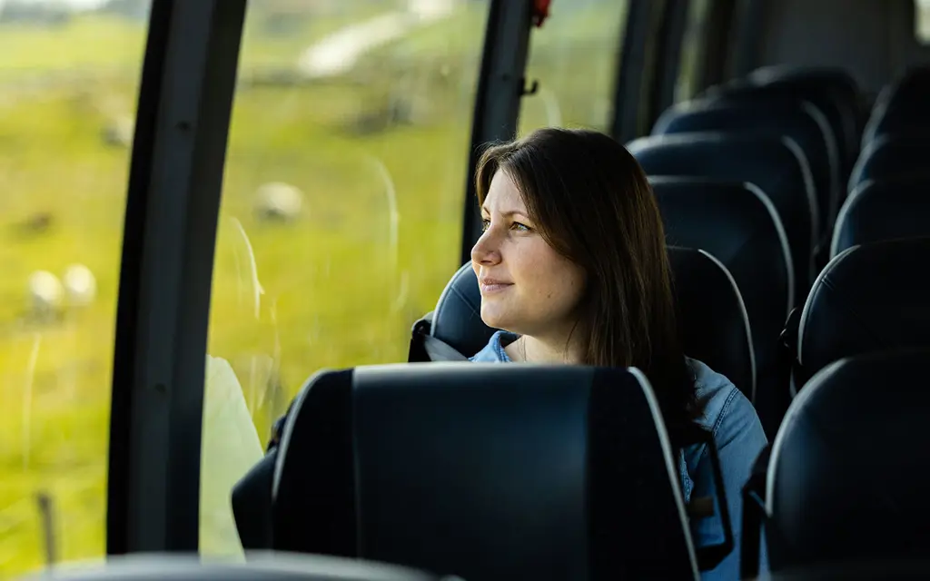 Passenger looking out of the window in the bus