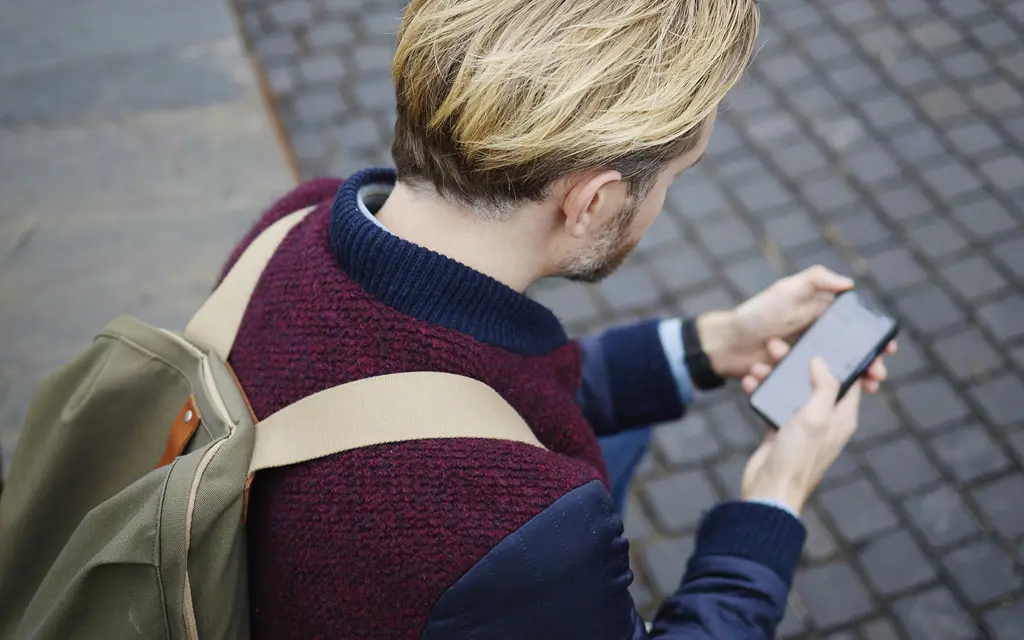 Man checking his bus ticket on his phone